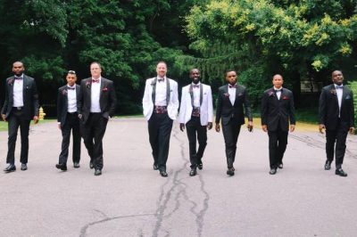 The groomsmen and the couple take a stroll before the reception