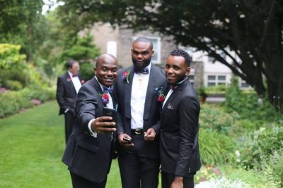 Groomsmen pose for a selfie before the reception.  