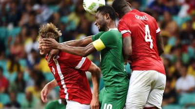 Crunchy! Mikel Obi sandwiched between two Danish players
