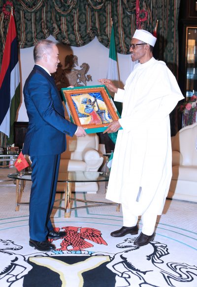 President Muhammadu Buhari presenting a parting gift to the outgoing Ambassador of the Socialist Republic of Vietnam, Mr. Hoang Hgoc Ho during a farewell audience at the State House in Abuja.