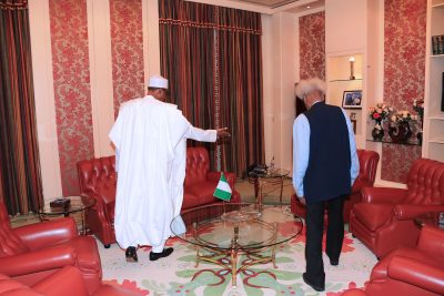 President Muhammadu Buhari usher in Prof. Wole Soyinka to his seat during a meeting at the State House in Abuja.