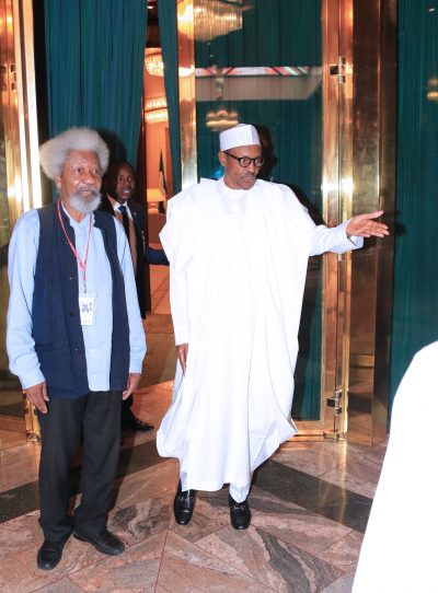 President Muhammadu Buhari leads Prof. Wole Soyinka out after the meeting