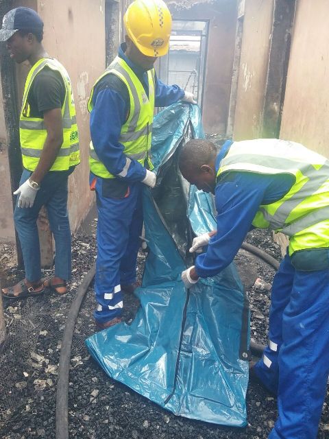 The remains of the octogenarian being gathered