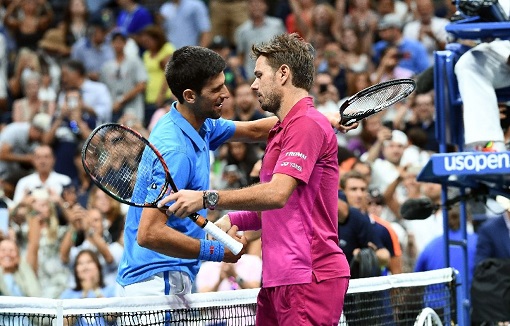 Novak Djokovic and Stanilas Wawrinka embrace after the latter stunned the former in New York
