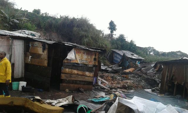 The collapsed shanties after the mudslide fell on them