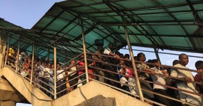 Pedestrians using the Ojota foot bridge.