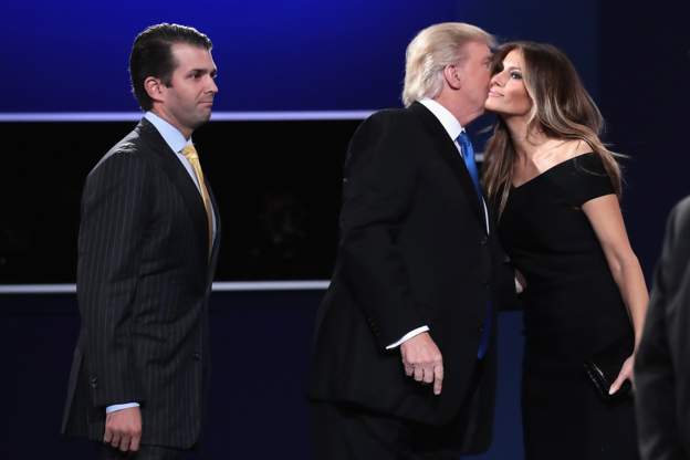 Donald Trump (C) kisses his wife, Melania Trump, while son, Donald Trump, Jr (L) looks on. Getty Image