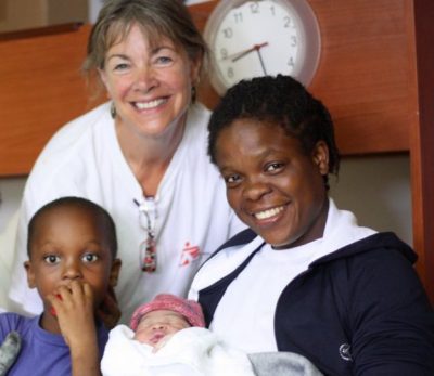 The mother and the nurse who delivered her of the baby