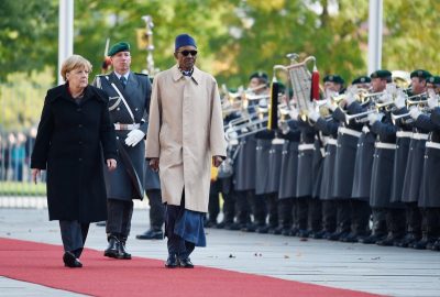 German Chancellor Angela Merkel, left, and the President of Nigeria Muhammadu Buhari, right, review the guards of honor prior to talks at the chancellery in Berlin, Friday, Oct. 14, 2016.