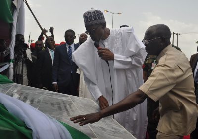 President Muhammadu Buhari unveils the plaque, assisted by Governor Adams Oshiomhole, at the commissioning of the 6-lane Upper Siluko road, with street lights and walkways, in Benin City, on Monday.