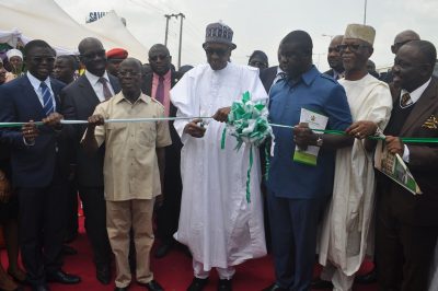 President Muhammadu Buhari cuts the tape to commission the new 200-bed Central Hospital in Benin City. He is flanked by Chief John Odigie-Oyegun, National Chairman All Progressives Congress (APC) (left) and Governor Adams Oshiomhole, on Monday.