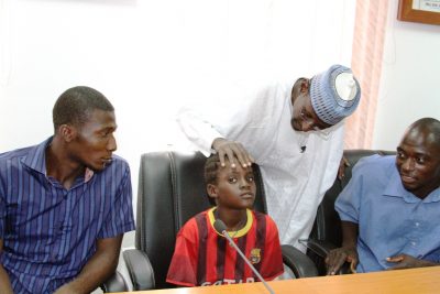 : FCT Minister, Malam Muhammad Musa Bello reassuring 9-year old Odo Ana, rescued with 9 others from the kidnappers’ hideout in Kuje Area Council, Abuja, when they were brought to the FCT Minister’s office…Monday. 