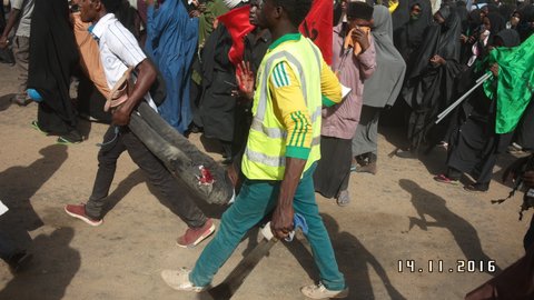 Injured IMN member being carried by colleagues