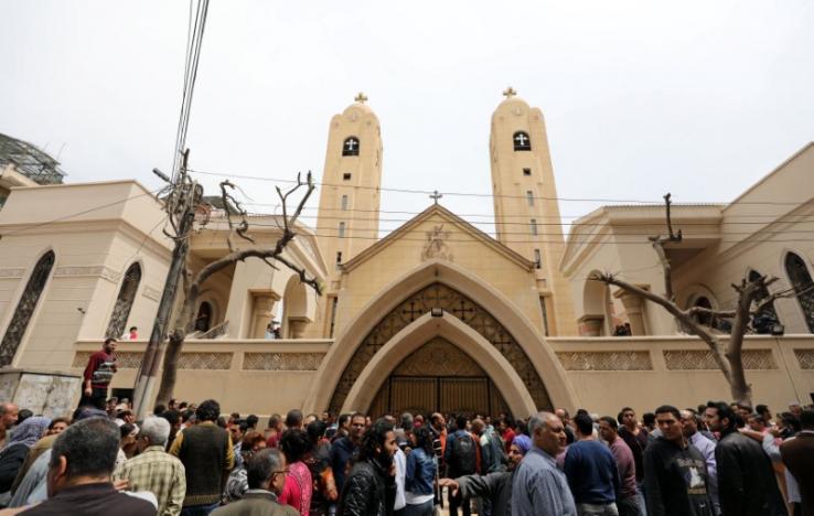 Egyptians gather in front of a Coptic church that was bombed on Sunday in Tanta