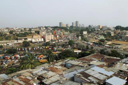 FILE PHOTO: Buildings in the business district Plateau are seen behind the village of Attiekoube in Abidjan