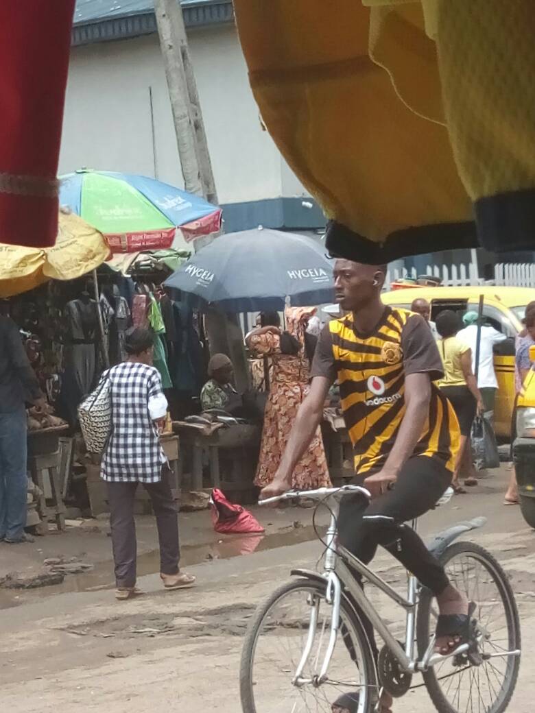 A young man riding bicycle at Bariga Market.