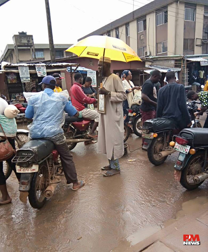 Ile-Epo bike men undeterred despite the rain.