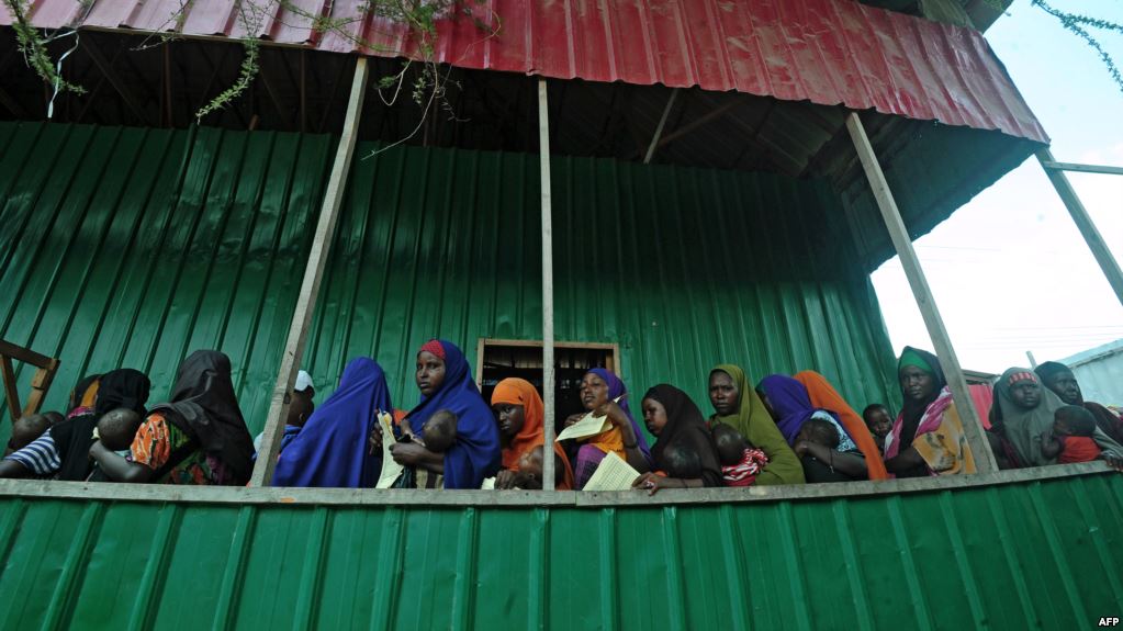 Newly displaced Somali women queue with their malnourished children as they try to receive medical treatment on outskirts of Mogadishu on April 11, 2017.