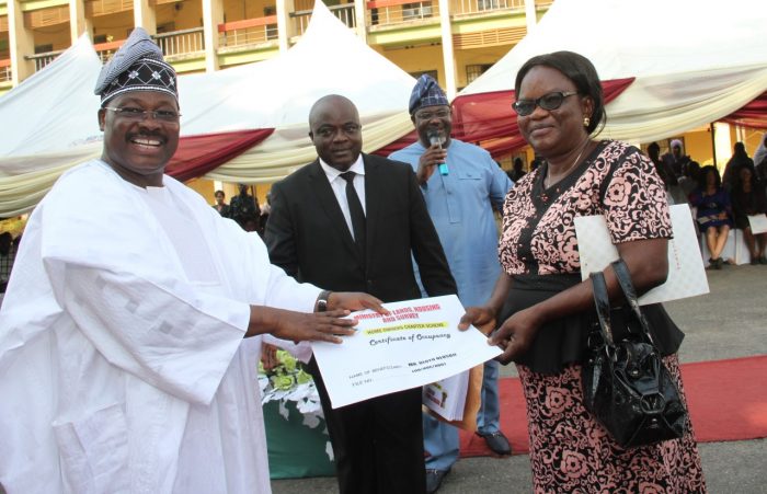 Governor Abiola Ajimobi of Oyo State presenting C of O to Mrs. Olotu Olusoji, under the state Home Owners Charter to one of the beneficiaries of the scheme. (1)