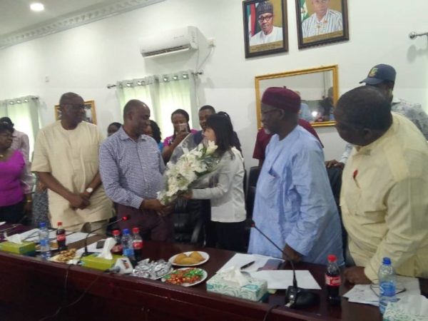 Amaechi-being-presented-flowers-by-a-represntative-of-one-of-the-Lagos-Ibadan-rail-contractors–e1557612934281