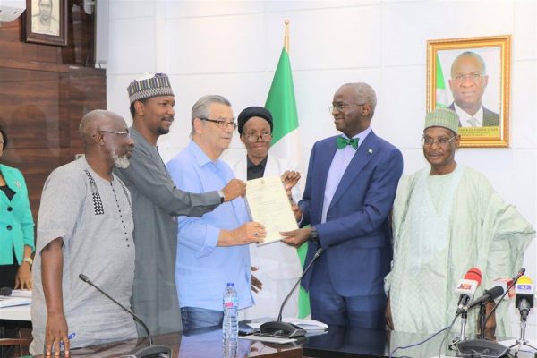 Clemens Westerhoff, 3rd from left gets the document for his house gift from Fashola