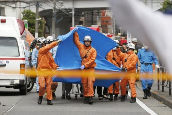 Rescue workers at the scene of the mass stabbing at a bus stop in Greater Tokyo