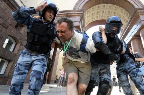 An opposition protester arrested by Russian police in Moscow
