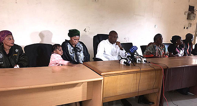 Andrew Edaile, middle, with Olubunmi Edaile, wife of murdered police inspector Mark Edaile