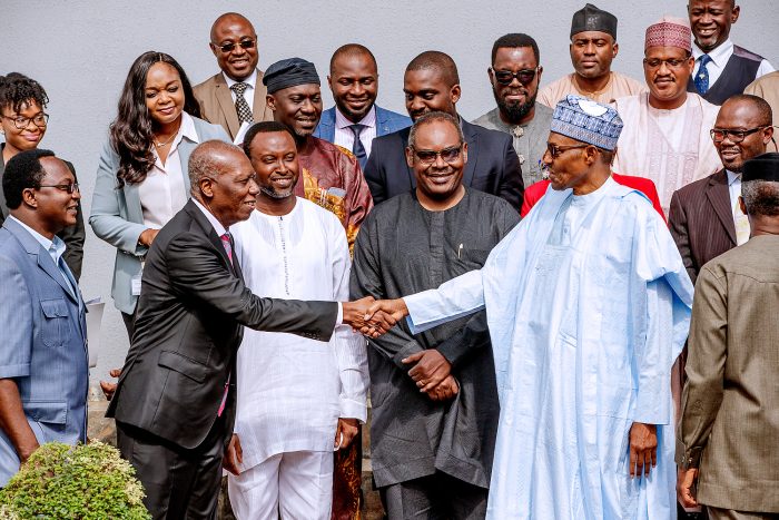 Buhari in a handshake with Osakwe