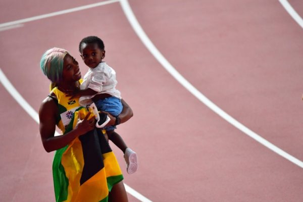 Fraser Pryce celebrates 100m gold with son