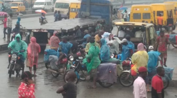 Lagosians wear nylon raincoats