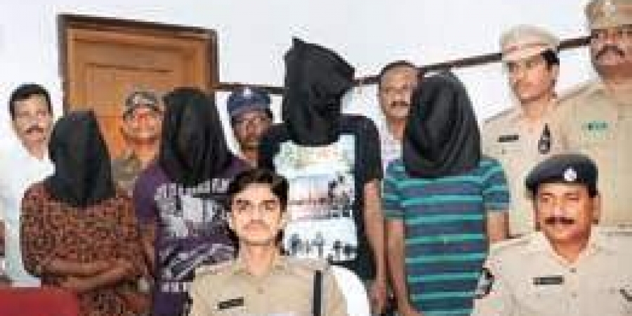 42 year-old Samuel Uche, hooded second left arrested in India