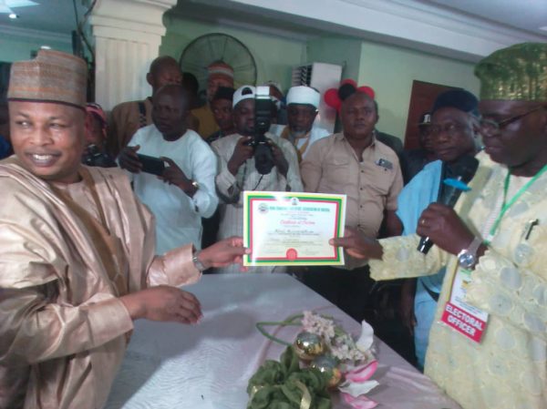 Mohammed Musa, left gets his certificate of return