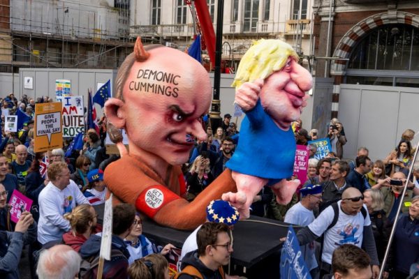 Pro-EU demonstrators with caricatures showing Boris Johnson is a puppet of Dominc Cummings