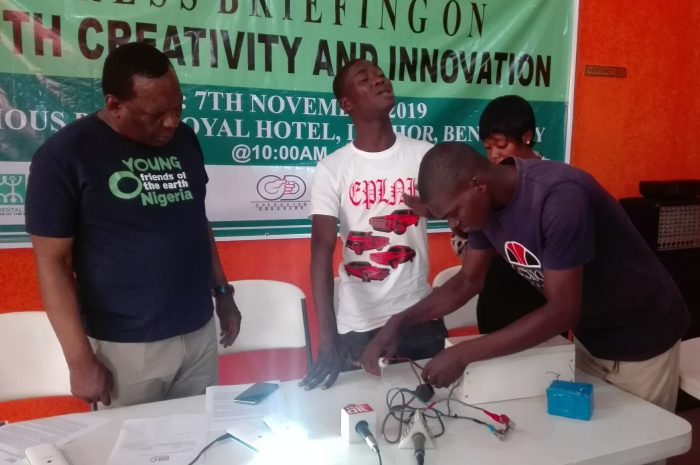 Daniel and Japheth testing their solar inverter to the admiration of Dr Ojo