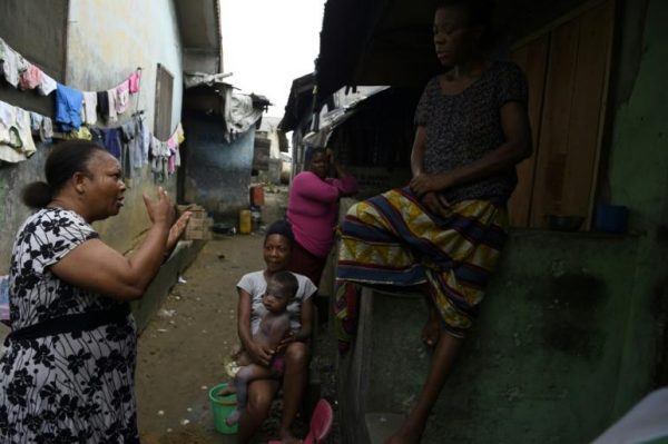MSF volunteer Christine Harrison, left, talks to a family in Diobu Port Harcourt about sexual abuse