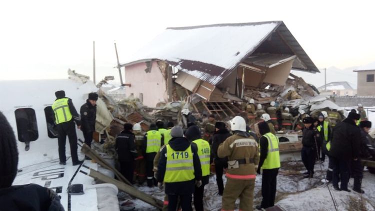 Rescue agents at the site of the crash in village near Almaty , Kazakhstan