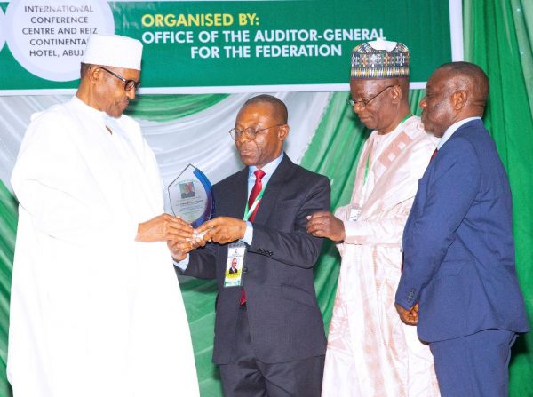 Buhari receives the award from AGF Ayine