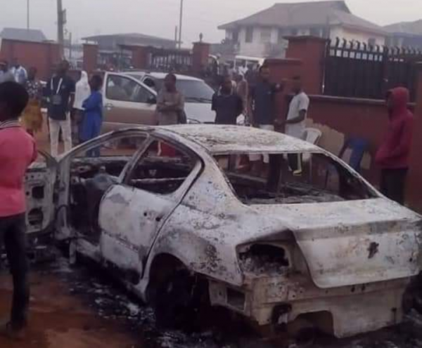 One of the vehicles set ablaze at the rally venue in Auchi