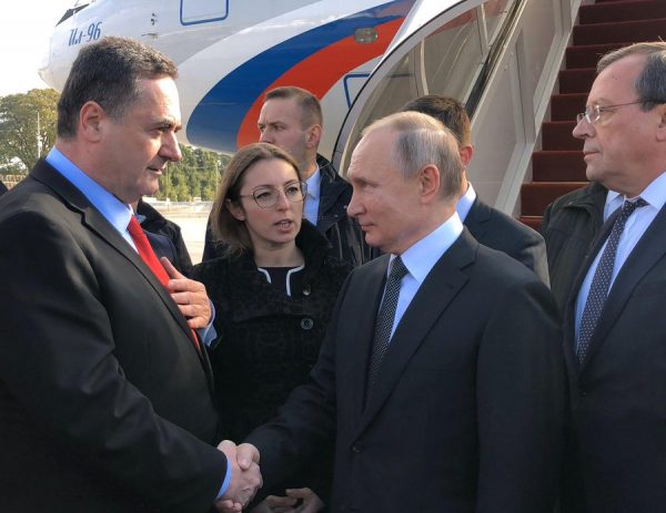 Putin, right, being received in Tel Aviv by Israeli foreign minister Katz