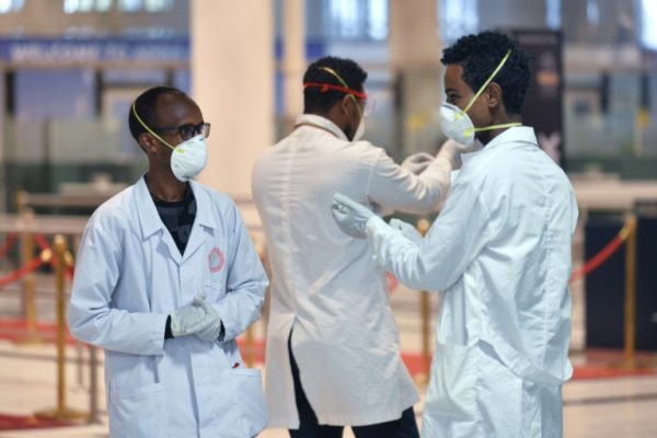Ethiopian health workers set to test arrivals at the international airport in Addis Ababa