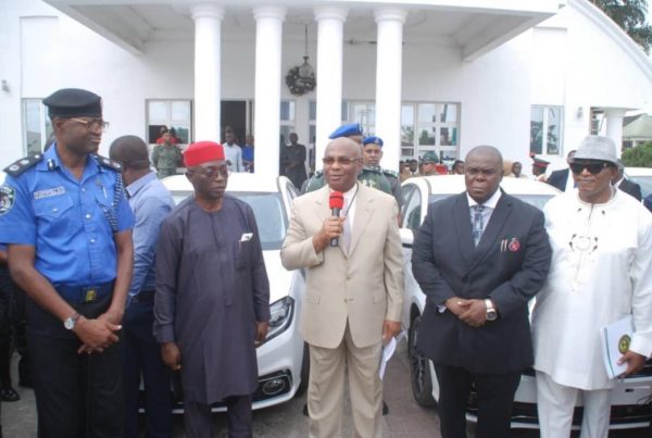 Governor Hope Uzodinma at the ceremony to present cars to 18 permsecs. Left is State Police commissioner Bolaji Fafowora
