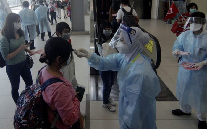 Travellers being tested at the Malaysia airport on arrival