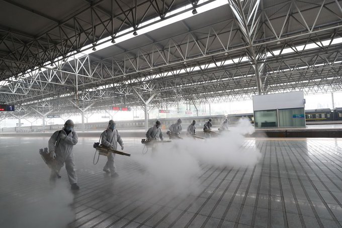 China health workers disinfect Wuhan train station