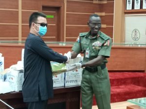 The Chief of Defence Training and Operations, Maj.-Gen. Lucky Irabor, receiving medical items donated to Defence Headquarters by the Mutual Commitment Company Ltd from its Managing Director, Mr Liu Zhao Lung in Abuja on Monday, 30/3/2020.