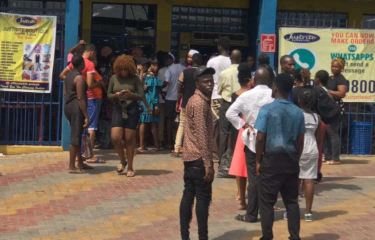 Patrons queue to get their temperature checked and hand sanitizer before being allowed into the Justrite Superstore, Abuleegba. PMnews correspondent confirms that not more than 50 persons are allowed in the store.