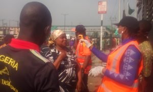 FILE PHOTO: People subjected to test against coronavirus before entering Mile 12 International Market
