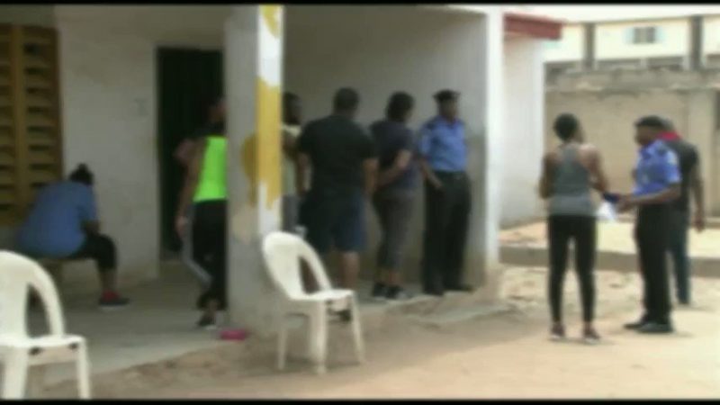 A Blurred image of a jogger, 3rd right, arrested by Police in Abuja