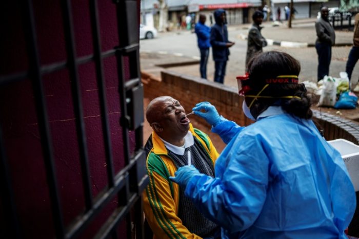 A health worker takes the swab sample of a man in Yeoville Johannesburg