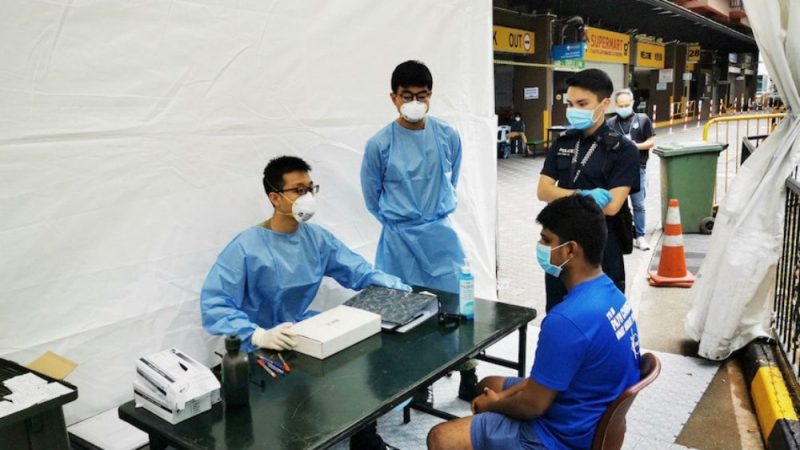 A migrant worker in Singapore goes for coronavirus testing